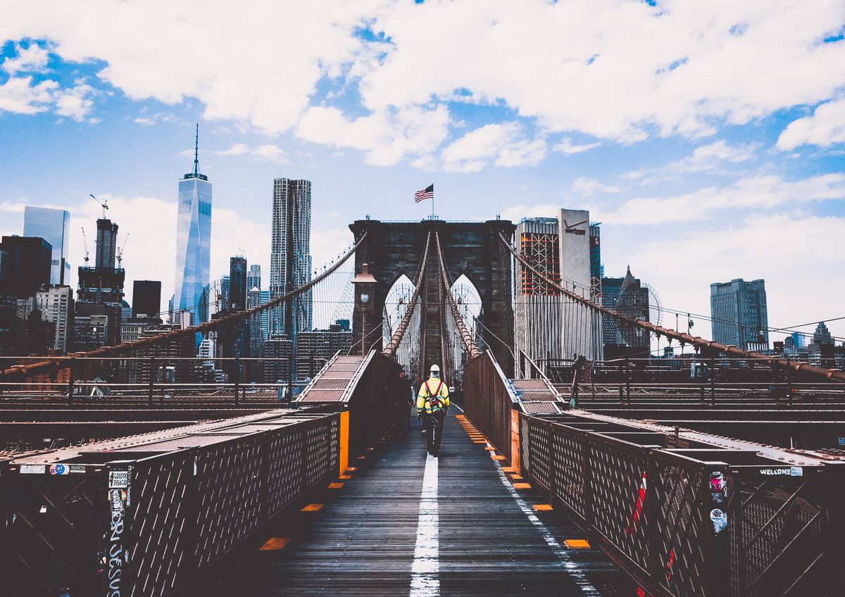 A person walking on a city bridge