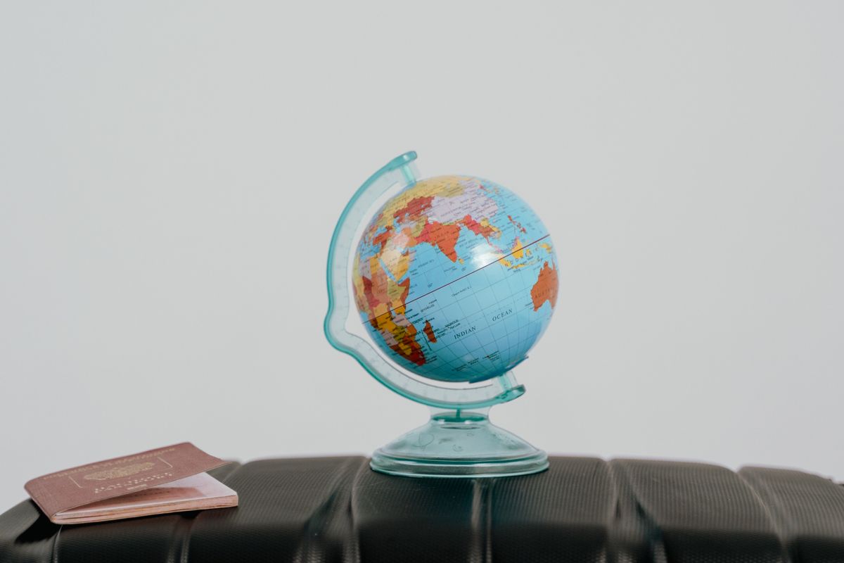 A passport and globe used for travel planning